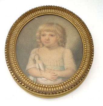 Portrait of a young girl holding her doll