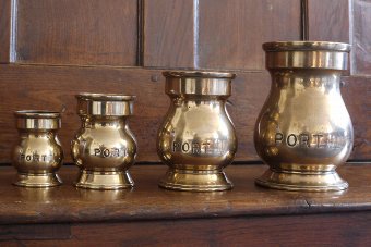 Set of four brass tankards