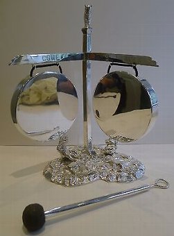A magnificent and rare find, this is a most charming figural double dinner gong