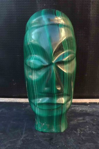 easter island head in carved malachite stone