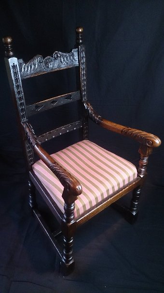 A British carved oak rail back armchair in the seventeenth century style
