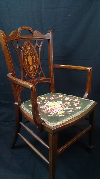 An Edwardian mahogany and inlaid open armchair.