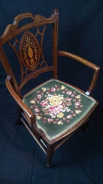 Antique An Edwardian mahogany and inlaid open armchair.