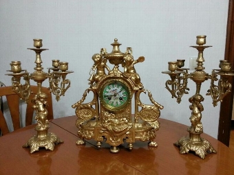 Amazing antique bronze clock gold plated 1800-1850 with his candleholders