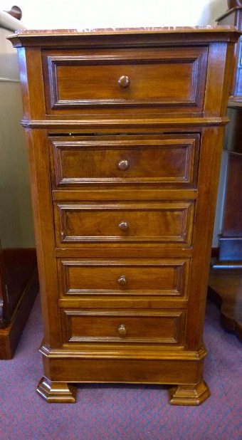 Elegant and slim this chest of drawers and bedside cabinet with central cupboard in walnut