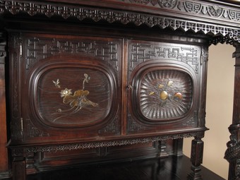 Antique Japonism. Aesthetic movement. A very interesting European walnut cupboard, mounted with Japanese lacquered panels.