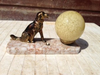 Antique  24cm high by 14cm in depth French Art-deco, marble based side-table lamp with bronze coloured spelter figure of a dog, sitting next to a beige coloured globe