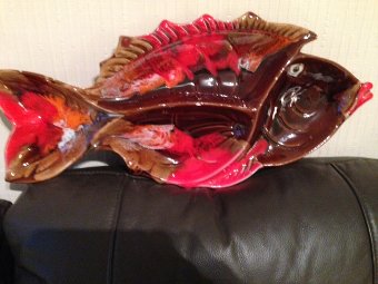 Strikingly coloured in red and brown this mid-20th century French ceramic 47cm by 21cm fish plate unsigned.