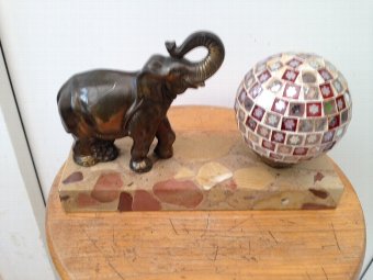 Art-deco 25cm by 16cm by 5cm small side table lamp with an elephant standing on a marble base next to a multi-mirrored ball lamp shade
