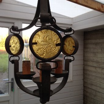 An exceptionally stylish French early 20th century arts and craft chandelier with a matching pair of baton style wall lights
