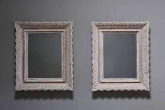 A pair of carved wood and gessoed mirrors by Bouche