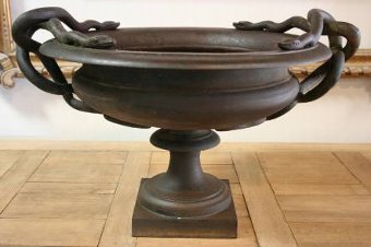 A fantastic C19th cast iron urn with serpent handles