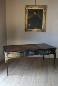 A grand C19th ebonised French bureau plat
