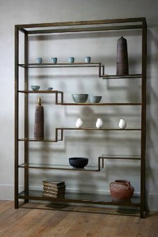 A large 1960s brass and glass display shelf