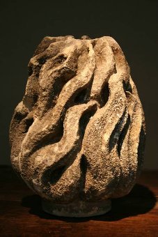A large and sculptural C18th stone torchere finial