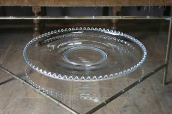 A 1950s glass ball charger