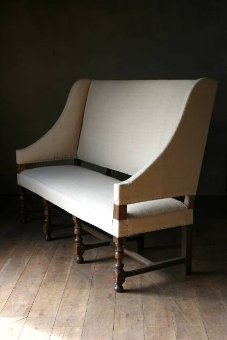 An C18th French oak wing back settee