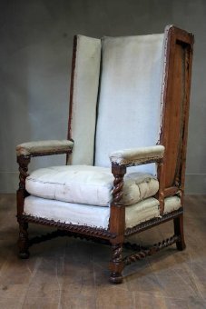 An unusual C19th oak wing chair by Marsh Jones and Cribb