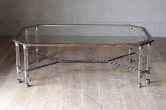 A large brass and lucite coffee table