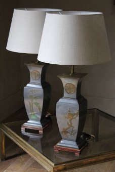 A pair of brass inlaid pewter lamps