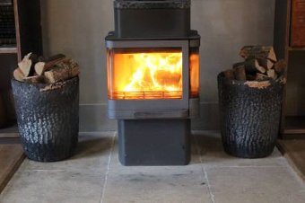 A pair of cast brazier log bins