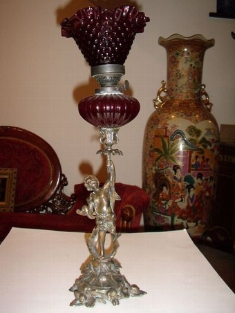 BRONZE CHERUB CANDLESTICK OIL LAMP WITH CRANBERRY GLASS SHADE C1850 
