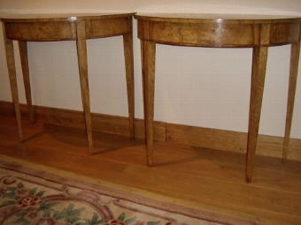 Antique A PAIR OF FINE REGENCY DESIGN DEMI-LUNE CONSOLE TABLES VENEERED IN FINELY CRAFTED YEW,SATINWOOD,MAHOGANY AND BURR-WALNUT HAVING EBONY STRINGING & CHERRYWOOD INLAY & STANDING ON TAPERED LEGS 