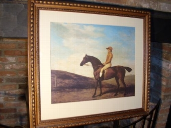 EARLY SPORTING PRINT OF A MOUNTED JOCKEY PRESENTED IN A BEAUTIFULLY CARVED DECORATIVE OAK FRAME  ...