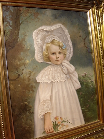 Antique 19TH.CENTURY VICTORIAN OIL ON CANVAS PORTRAIT OF A BEAUTIFUL YOUNG GIRL WEARING HER COTTON & LACE WHITE DRESS WITH BONNET TIED UNDER CHIN SEEN HOLDING FLOWERS PRESENTED IN A SWEPT GILT LATER FRAME SIZE 23.25 X 19.25 INCHES