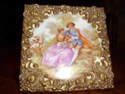 PORCELAIN CAMEO FRAMED IN PRESSED GILT BRASS FRAME