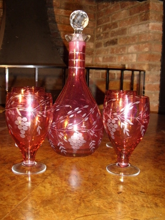 Antique CRANBERRY GLASS DECANTER SET WITH FOUR GLASSES HAVING ETCHED DESIGN 