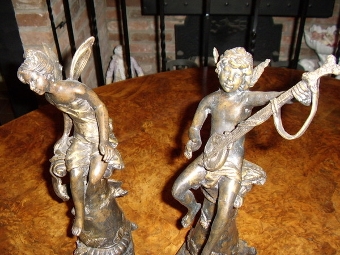 Antique PAIR OF BRONZE ART NOVEAU BOY & GIRL ANGELS SITTING ON PLILLARS ONE PLAYING AN INSTRUMENT TO THE OTHER 