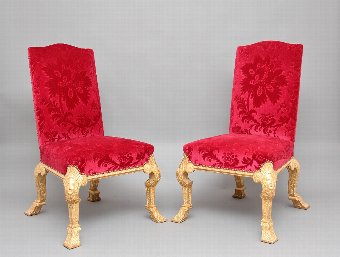 A pair of George I style gilt wood chairs