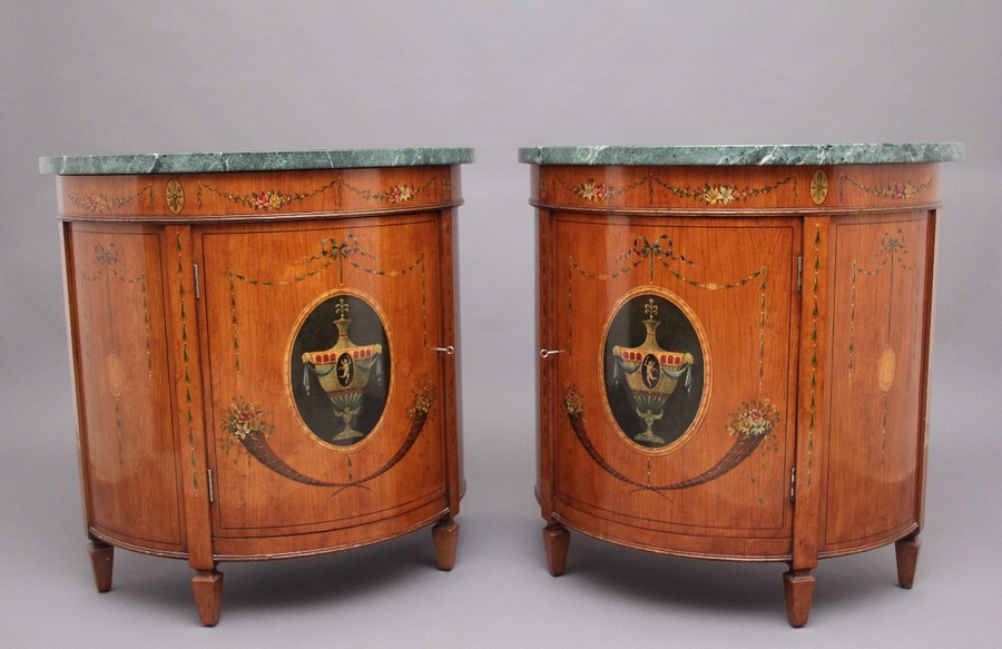 Pair of early 20th Century satinwood and painted demi lune cabinets