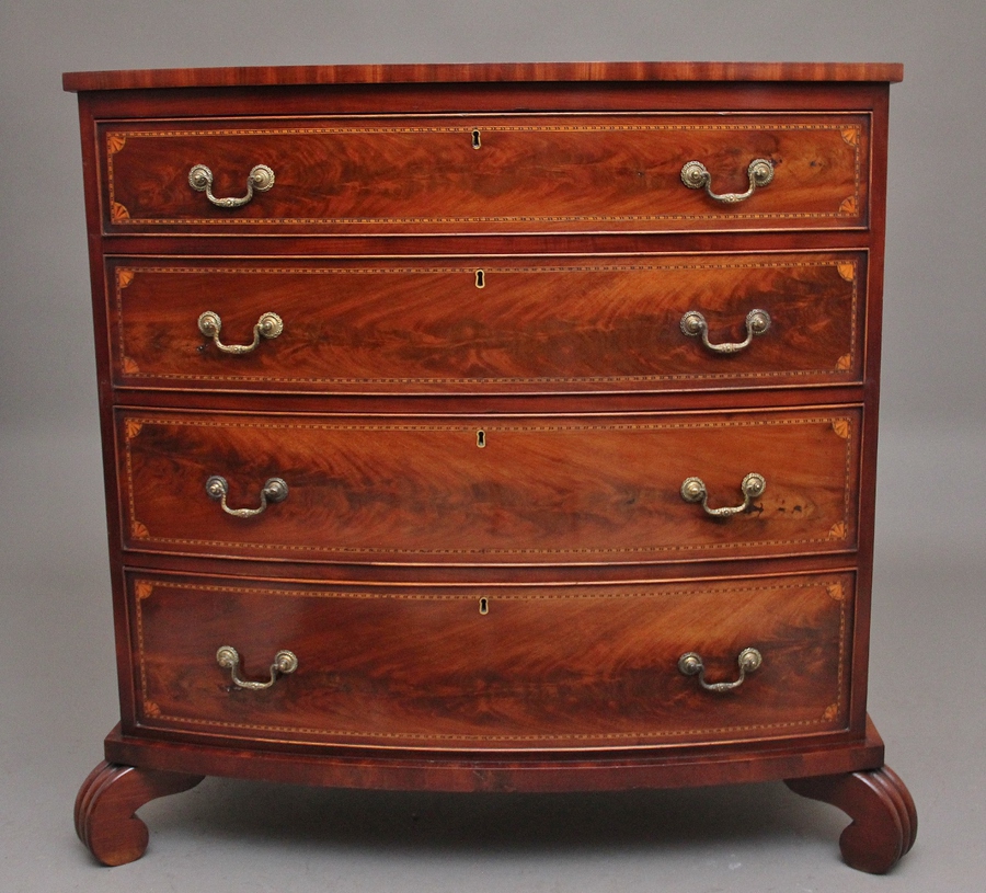 A highly decorative early 19th Century flame mahogany and inlaid bowfront chest of drawers