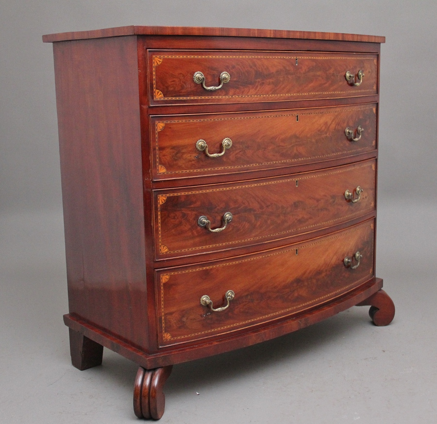 Antique A highly decorative early 19th Century flame mahogany and inlaid bowfront chest of drawers