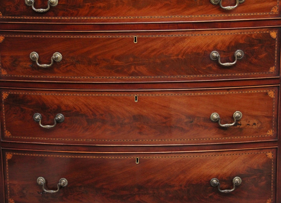 Antique A highly decorative early 19th Century flame mahogany and inlaid bowfront chest of drawers