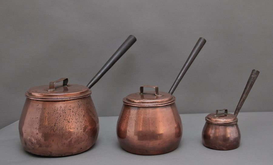 A set of three Victorian copper saucepans