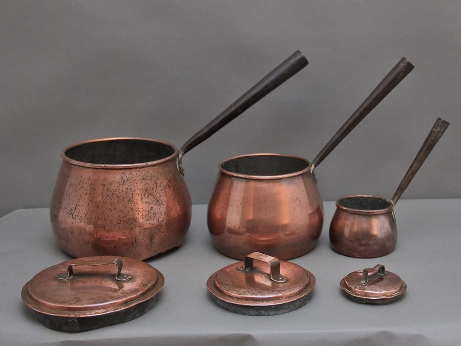 Antique A set of three Victorian copper saucepans