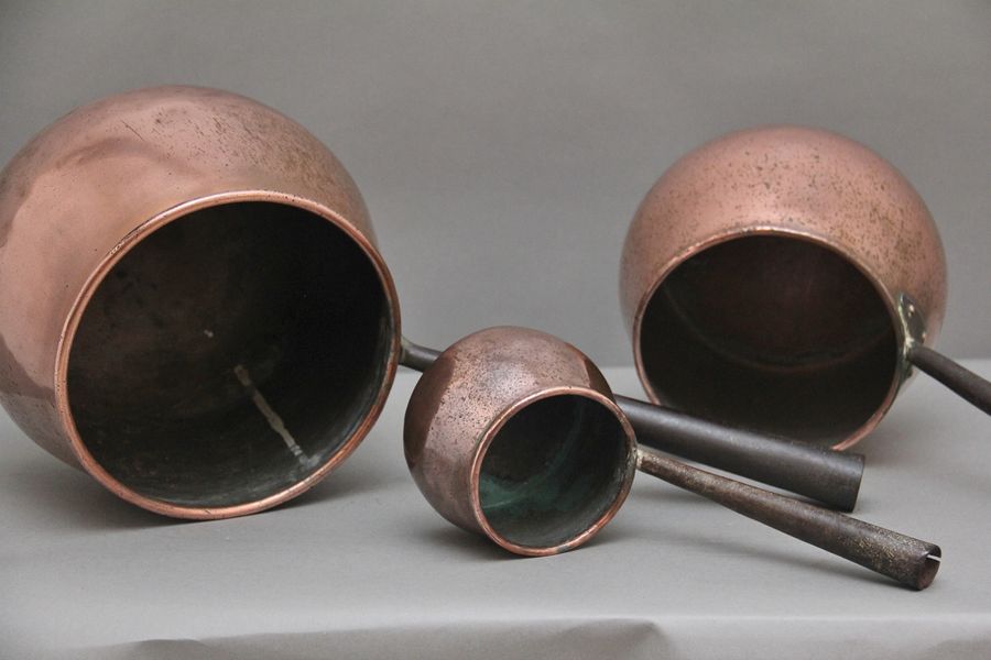 Antique A set of three Victorian copper saucepans