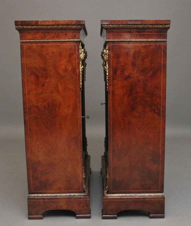 Antique Pair of 19th Century walnut pier cabinets by Edwards & Roberts