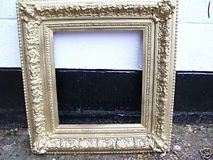 VERY OLD GILTWOOD CARVED FRAME WITH CARVED FACES