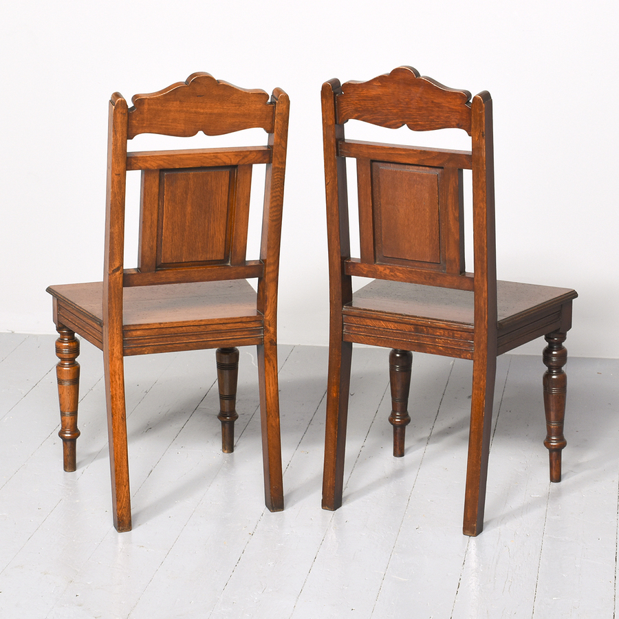 Antique Pair of Late 19th Century Aesthetic-Style Carved Oak Hall Chairs