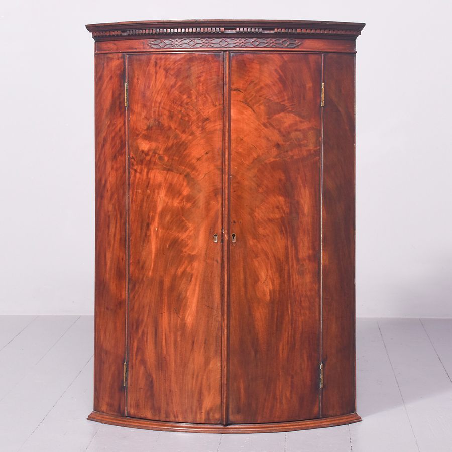 George III Bow-Front Figured Mahogany Hanging Corner Cupboard