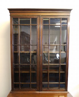 Antique Regency mahogany bookcase on cupboard