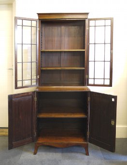 Antique Regency mahogany bookcase on cupboard