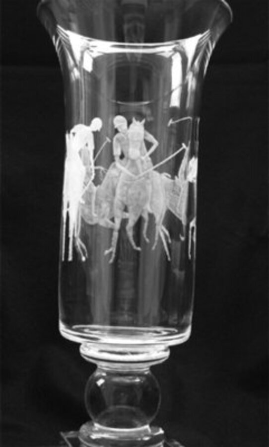 A 20th century enraved 24 percent lead crystal vase with four polo players and ponies. Engraved b...
