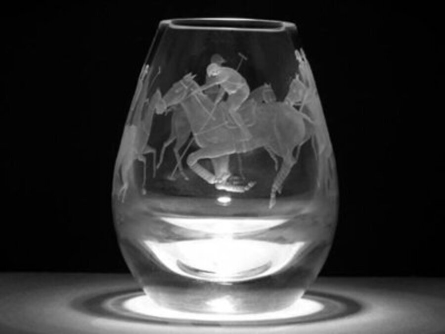A 20th century hand engraved with four polo ponies 100 percent lead crystal vase by Sandra Snaddo...