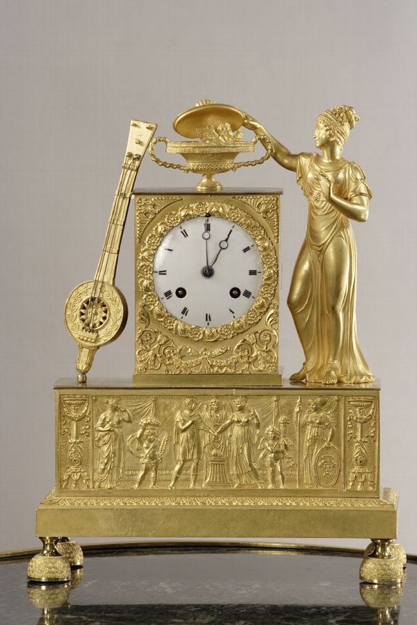 A gilt bronze clock with musician