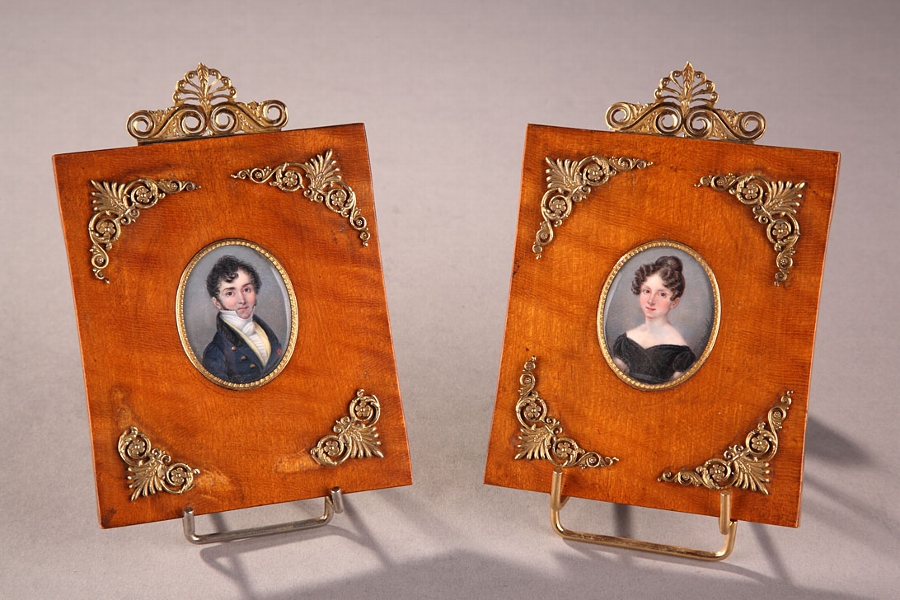 A pair of 19th century French oval miniatures on ivory signed Hyacinthe Mercier 1833